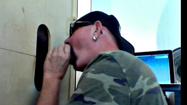 thick black cock teases hungry mouths at the gay gloryhole