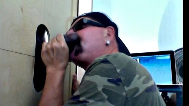 thick black cock teases hungry mouths at the gay gloryhole