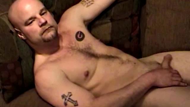 Shane is a big, cigar-smoking, hairy man, with a rough outdoors look. He works as a garbage man and is about to enter the Army. Enjoy as this muscular 28-year-old gets naked and strokes his hard cock.