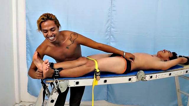 Introducing cute and ticklish Asian twink Jojo. This is his first shoot with Laughing Asians. Our long haired Asian boy Hunter is the sadistic tickler who has strapped Jojo on the tickle rack and puts him through his first tickle experience.