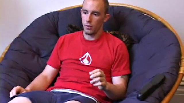 Lean and mean Corbin Ross peels of his jeans and plops down to start working his cock. He lifts his red shirt to reveal his flat abs and keep from soiling it with the cum he's working on.