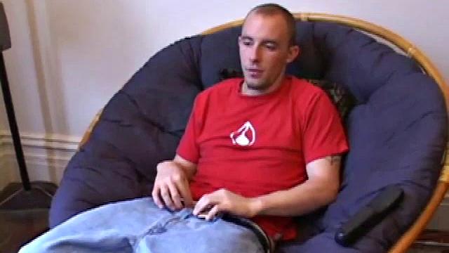 Lean and mean Corbin Ross peels of his jeans and plops down to start working his cock. He lifts his red shirt to reveal his flat abs and keep from soiling it with the cum he's working on.