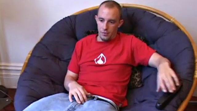 Lean and mean Corbin Ross peels of his jeans and plops down to start working his cock. He lifts his red shirt to reveal his flat abs and keep from soiling it with the cum he's working on.