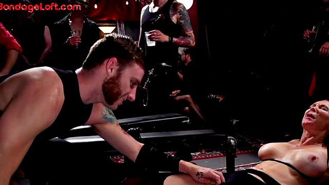 Busty BDSM redhead whipped in front of voyeurs