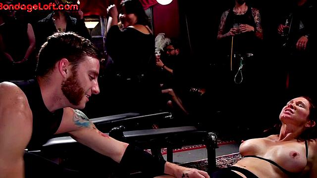 Busty BDSM redhead whipped in front of voyeurs