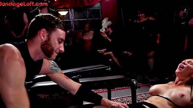 Busty BDSM redhead whipped in front of voyeurs