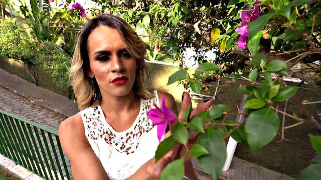 A tattooed Latina with high heels and pierced tits masturbate in her panties outside