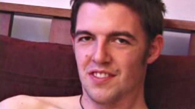 Garrett down to socks massages his cock, easily sliding fingers in his ass. He lubes up dildo, starts fucking himself until warm cum pumps out over stomach.