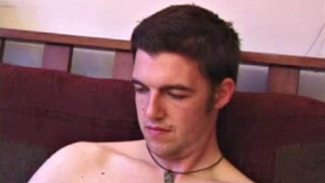 Garrett down to socks massages his cock, easily sliding fingers in his ass. He lubes up dildo, starts fucking himself until warm cum pumps out over stomach.