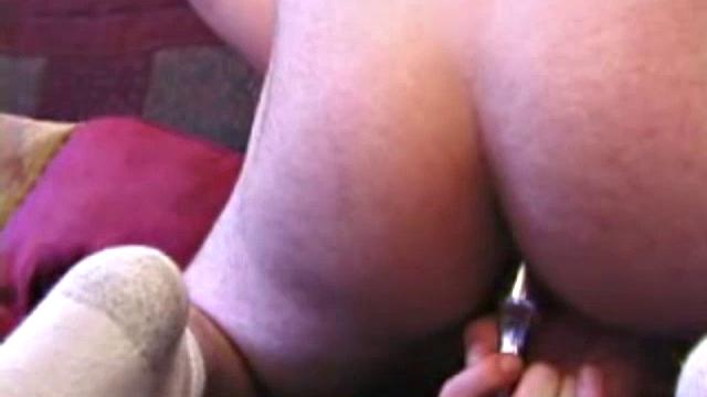 Garrett down to socks massages his cock, easily sliding fingers in his ass. He lubes up dildo, starts fucking himself until warm cum pumps out over stomach.