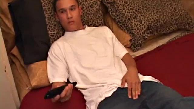 New to gay porn, 18 year old Arik is sweet, quiet and eager to please. With a video playing on the TV, Arik works his growing package, before stripping naked. His cock is already hard and he gets busy stroking it.