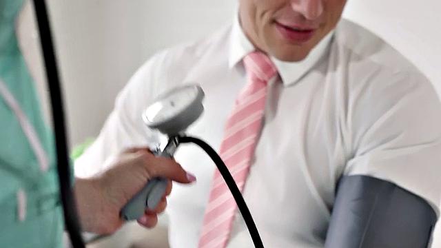 Naughty nurse with big tits gives patient a hot handjob in the office