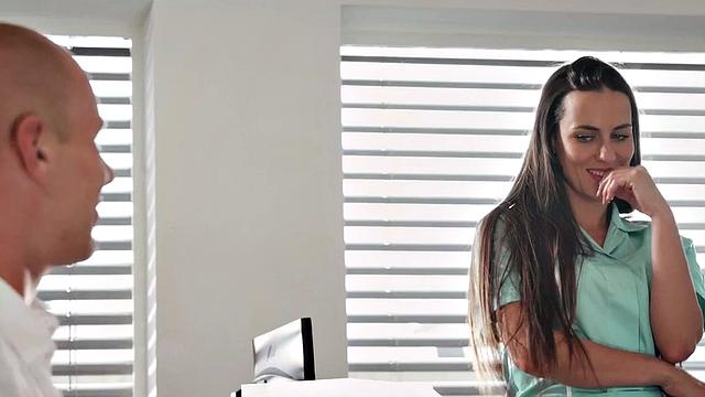 Naughty nurse with big tits gives patient a hot handjob in the office