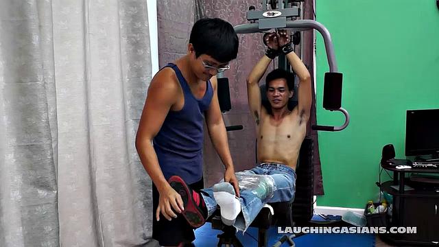 If you love male foot tickling, you're going to love this one! Cute Asian Boy Argie Comes by for a Gym Workout with His Trainer. The Gym Trainer Secures Argie for Vigorous Leg Workout.