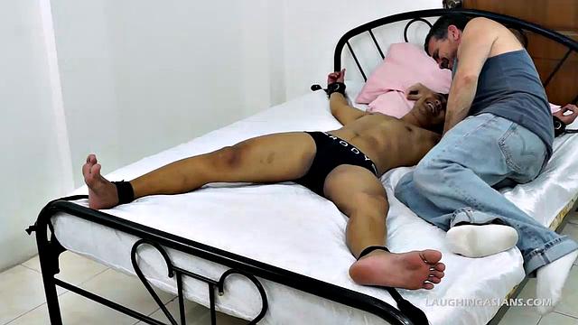 Me and a few of my cute ticklish Asian twinks are together again for an afternoon of tickle fetish fun. Today we have the adorable Asian boy Lance tied down spreadeagled on the bed.