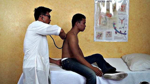 Slim Asian bottom fingered by medic before bareback sex