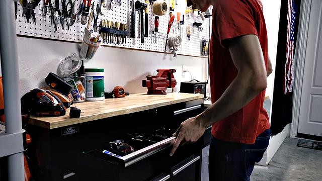Dad gets rough with his grown son on the workbench-guess that's one way to bond