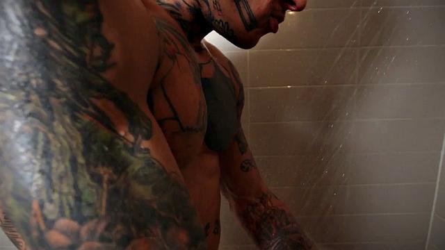 Inked hunk fucking twink in shower after blowjob
