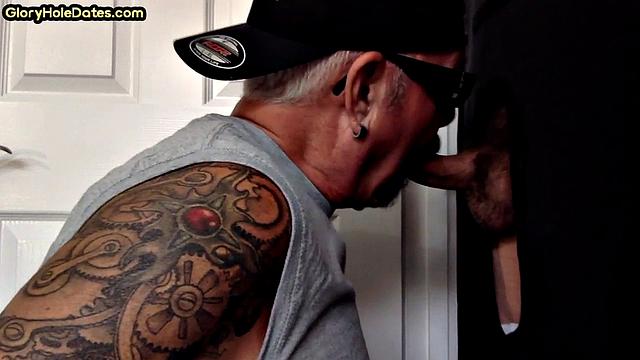 Tattooed DILF sucks gloryhole dick till cum in mouth