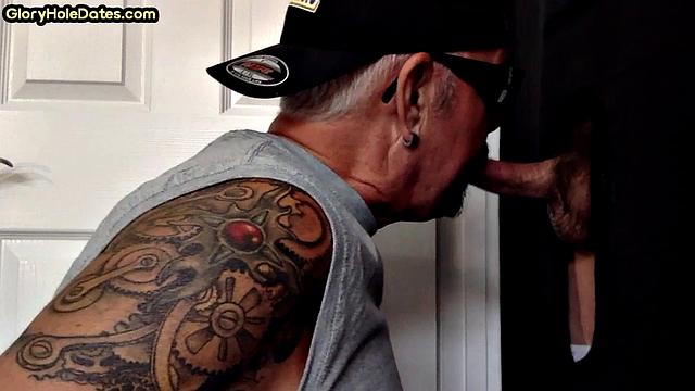 Tattooed DILF sucks gloryhole dick till cum in mouth