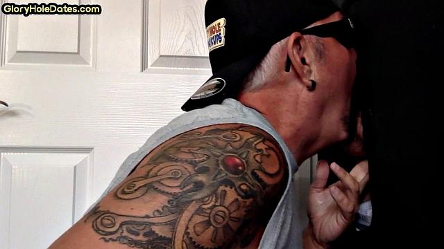 Tattooed DILF sucks gloryhole dick till cum in mouth