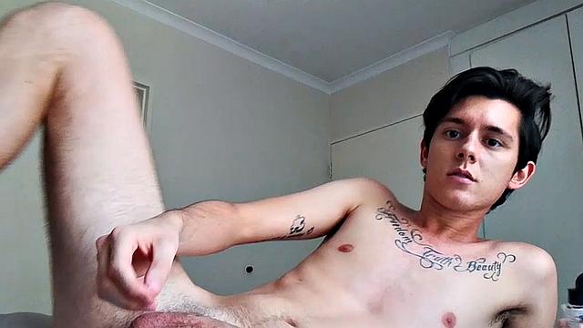 Ant is a slim and smooth twink, with that boy next door look, until the shirt peels off revealing an inked chest. He pushes his shorts down just enough to give us a peek at his fine looking little butt and big uncut cock.