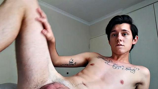 Ant is a slim and smooth twink, with that boy next door look, until the shirt peels off revealing an inked chest. He pushes his shorts down just enough to give us a peek at his fine looking little butt and big uncut cock.