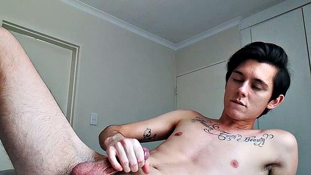 Ant is a slim and smooth twink, with that boy next door look, until the shirt peels off revealing an inked chest. He pushes his shorts down just enough to give us a peek at his fine looking little butt and big uncut cock.