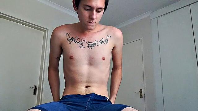Ant is a slim and smooth twink, with that boy next door look, until the shirt peels off revealing an inked chest. He pushes his shorts down just enough to give us a peek at his fine looking little butt and big uncut cock.