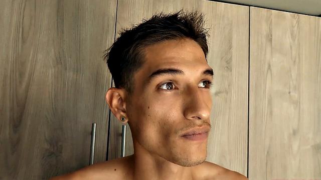 Shirtless Puma opens his pants to expose and gets big cock stiff.