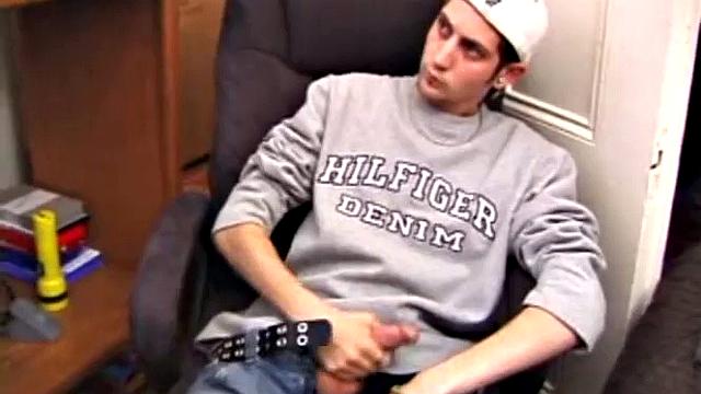 As a porn flick plays, young amateur Aaron Michaels strokes hard, pulls his cock out of his jeans, lets loose, and spills his nut on the bed.