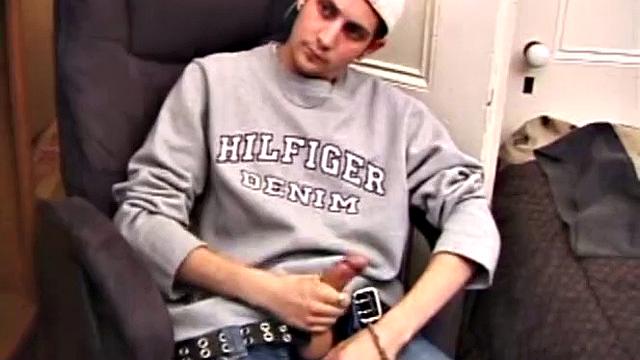 As a porn flick plays, young amateur Aaron Michaels strokes hard, pulls his cock out of his jeans, lets loose, and spills his nut on the bed.