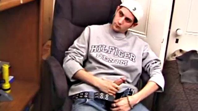 As a porn flick plays, young amateur Aaron Michaels strokes hard, pulls his cock out of his jeans, lets loose, and spills his nut on the bed.