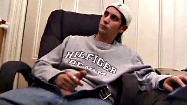 As a porn flick plays, young amateur Aaron Michaels strokes hard, pulls his cock out of his jeans, lets loose, and spills his nut on the bed.