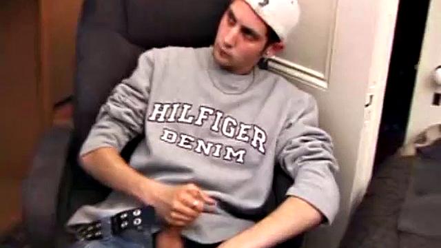 As a porn flick plays, young amateur Aaron Michaels strokes hard, pulls his cock out of his jeans, lets loose, and spills his nut on the bed.