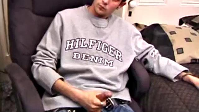 As a porn flick plays, young amateur Aaron Michaels strokes hard, pulls his cock out of his jeans, lets loose, and spills his nut on the bed.