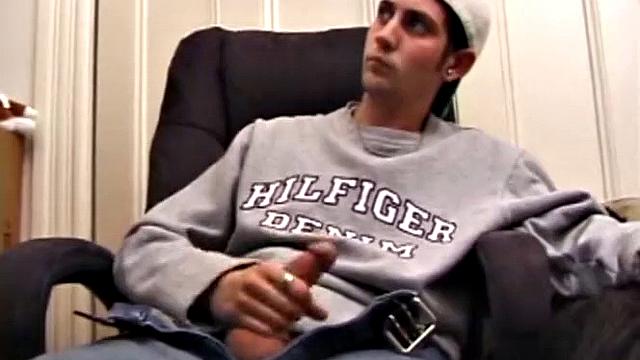 As a porn flick plays, young amateur Aaron Michaels strokes hard, pulls his cock out of his jeans, lets loose, and spills his nut on the bed.