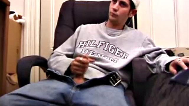 As a porn flick plays, young amateur Aaron Michaels strokes hard, pulls his cock out of his jeans, lets loose, and spills his nut on the bed.