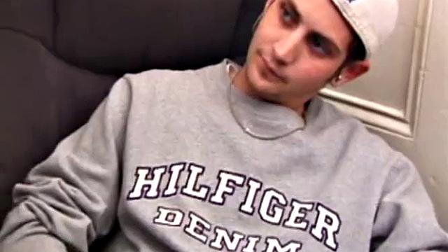 As a porn flick plays, young amateur Aaron Michaels strokes hard, pulls his cock out of his jeans, lets loose, and spills his nut on the bed.