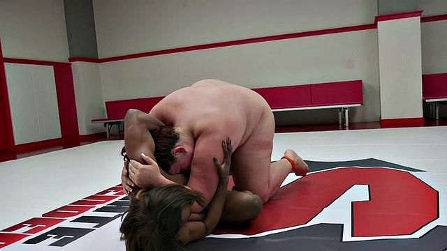 Chubby lesbian wrestler fights against Ebony on mat