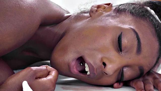 Oiled Ebony lez scissoring with white WAM masseuse on massage
