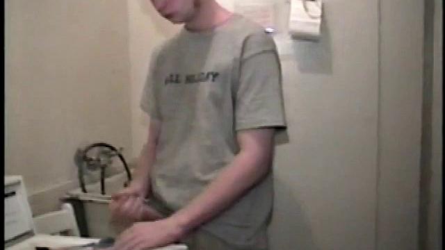 Boy-next-door spreads his new straight porn magazine on top of the washing machine and pulls his cock out of the fly.