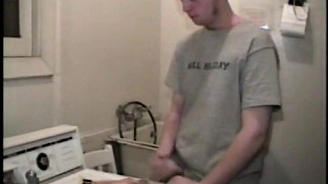 Boy-next-door spreads his new straight porn magazine on top of the washing machine and pulls his cock out of the fly.