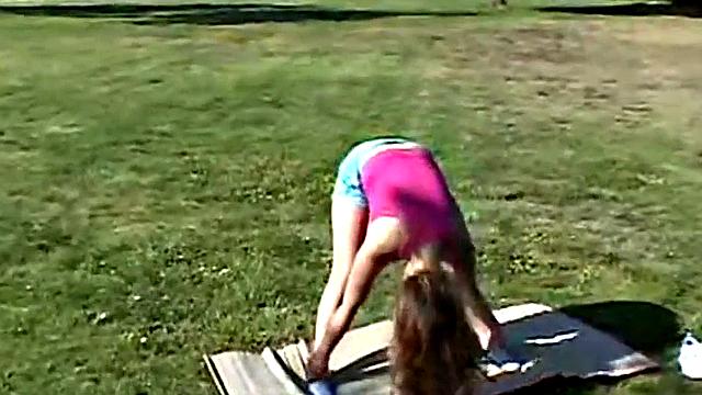Little April fingers her wet pussy in shorts outdoors