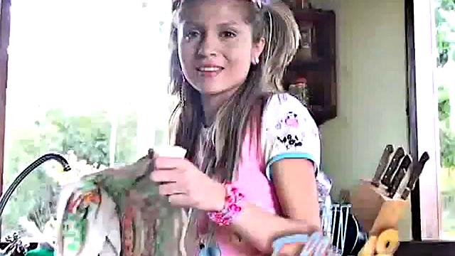 Petite blonde masturbates on the kitchen counter