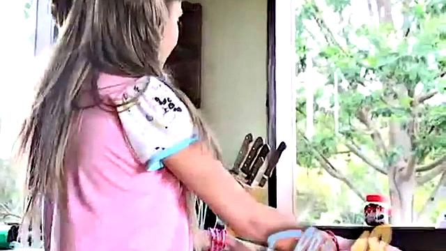 Petite blonde masturbates on the kitchen counter