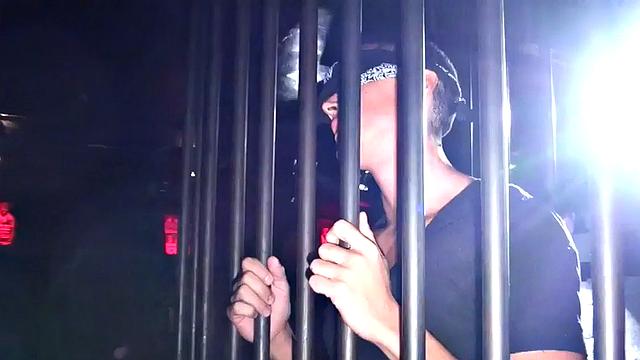 Blindfolded stud in cage fucks Black in gay club