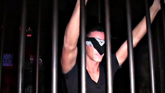Blindfolded stud in cage fucks Black in gay club
