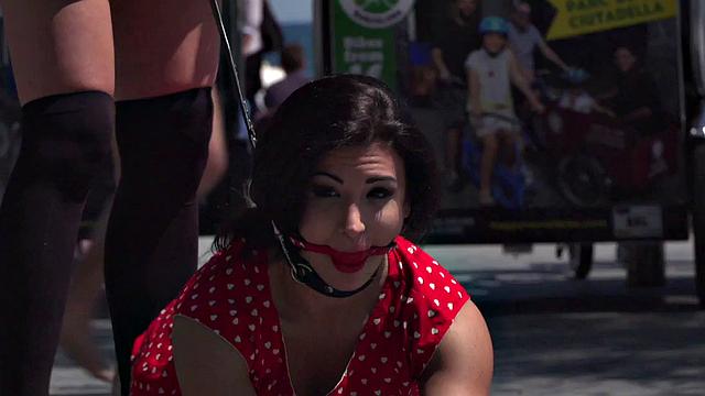Kinky tattooed brunette sub gagged and humiliated by her domme in public