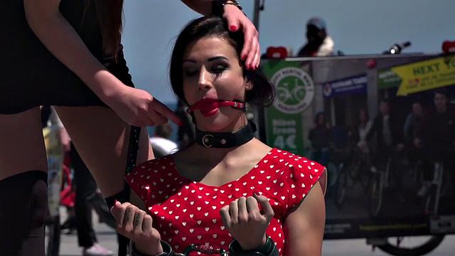 Kinky tattooed brunette sub gagged and humiliated by her domme in public